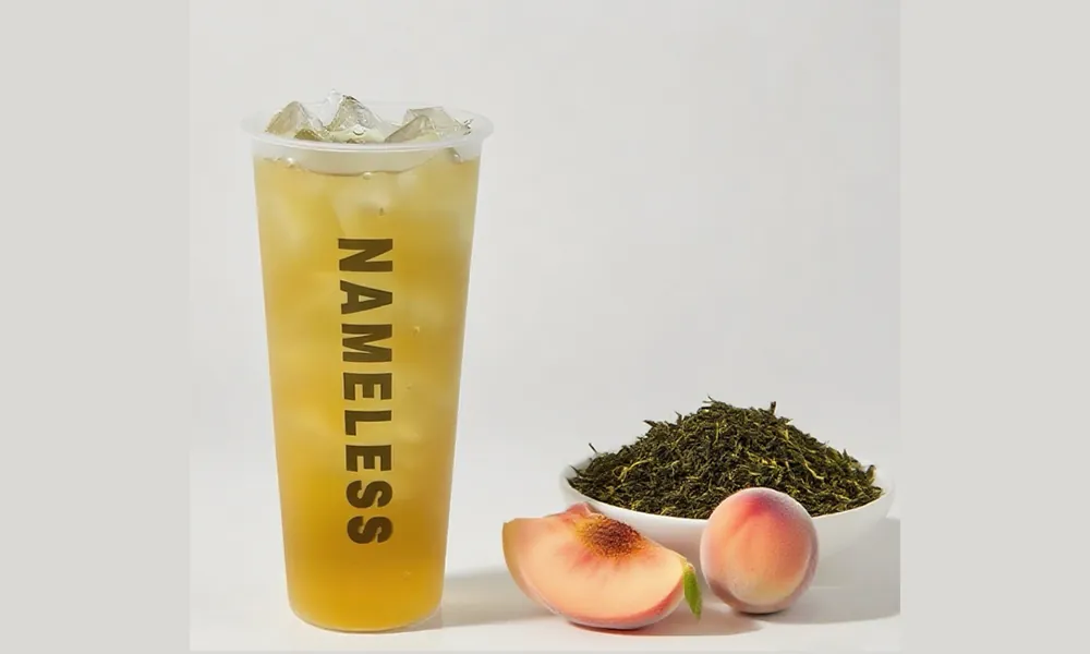 Iced oolong green tea with peach slices and tea leaves at Nameless Tea&Coffee, a Coffee Shop in Sacramento